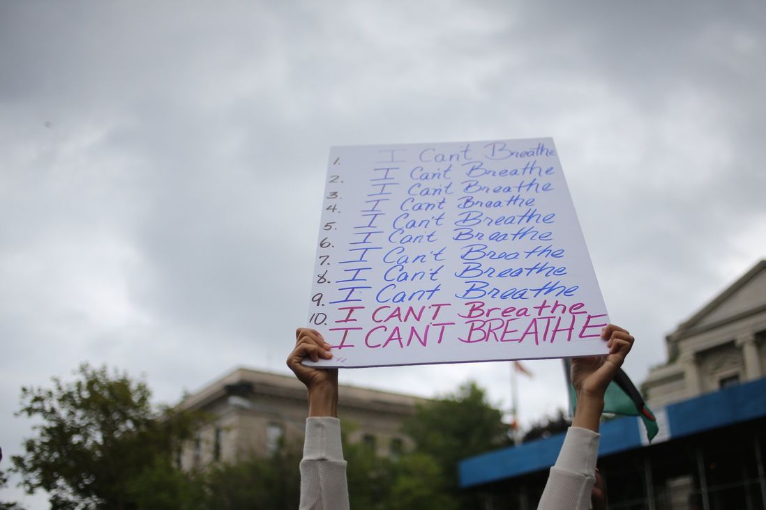 A sign at the rally lists the words “I can’t breathe” 11 times, the number of times Garner said it as he was being choked.